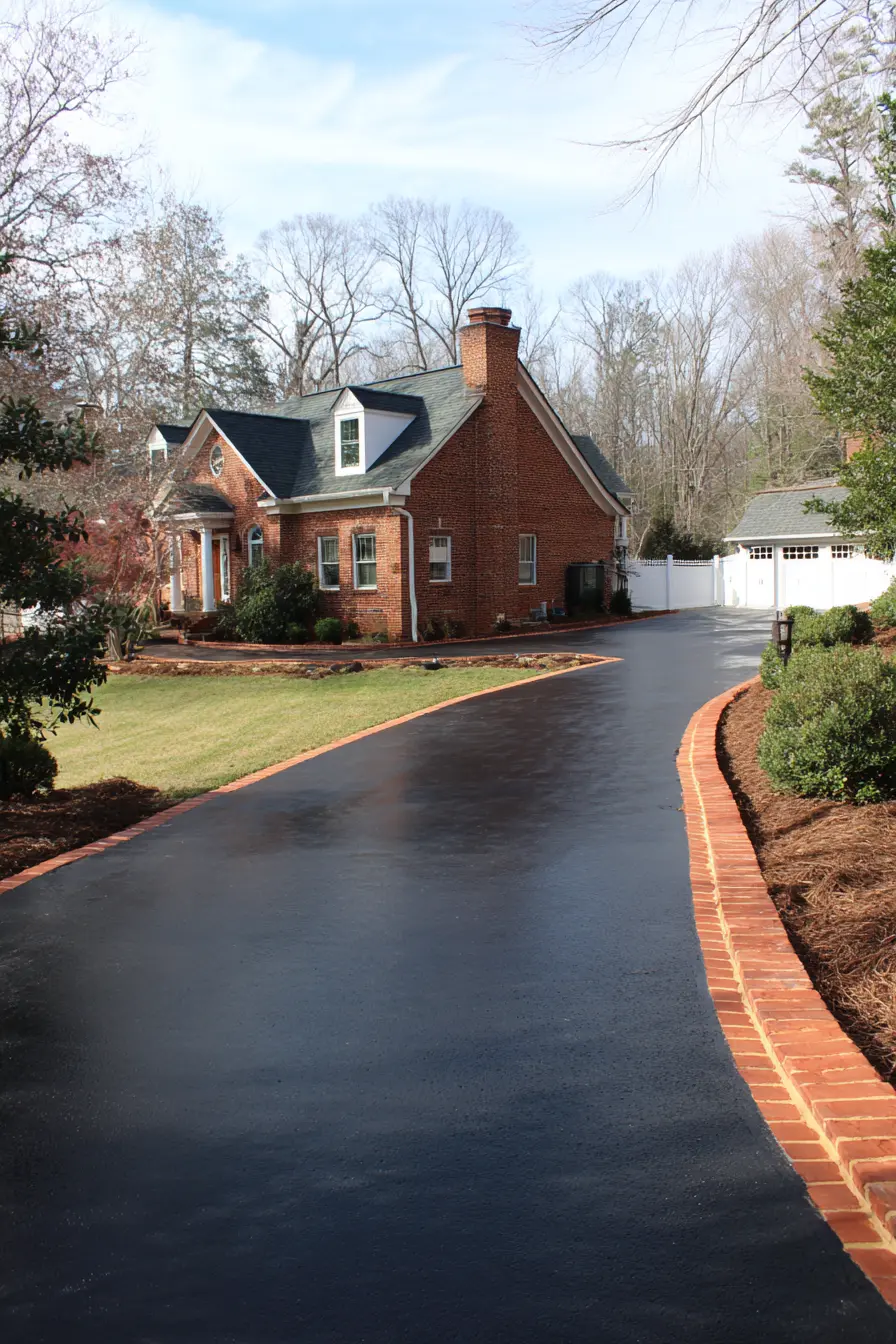 Sleek Asphalt Driveway with Brick Border